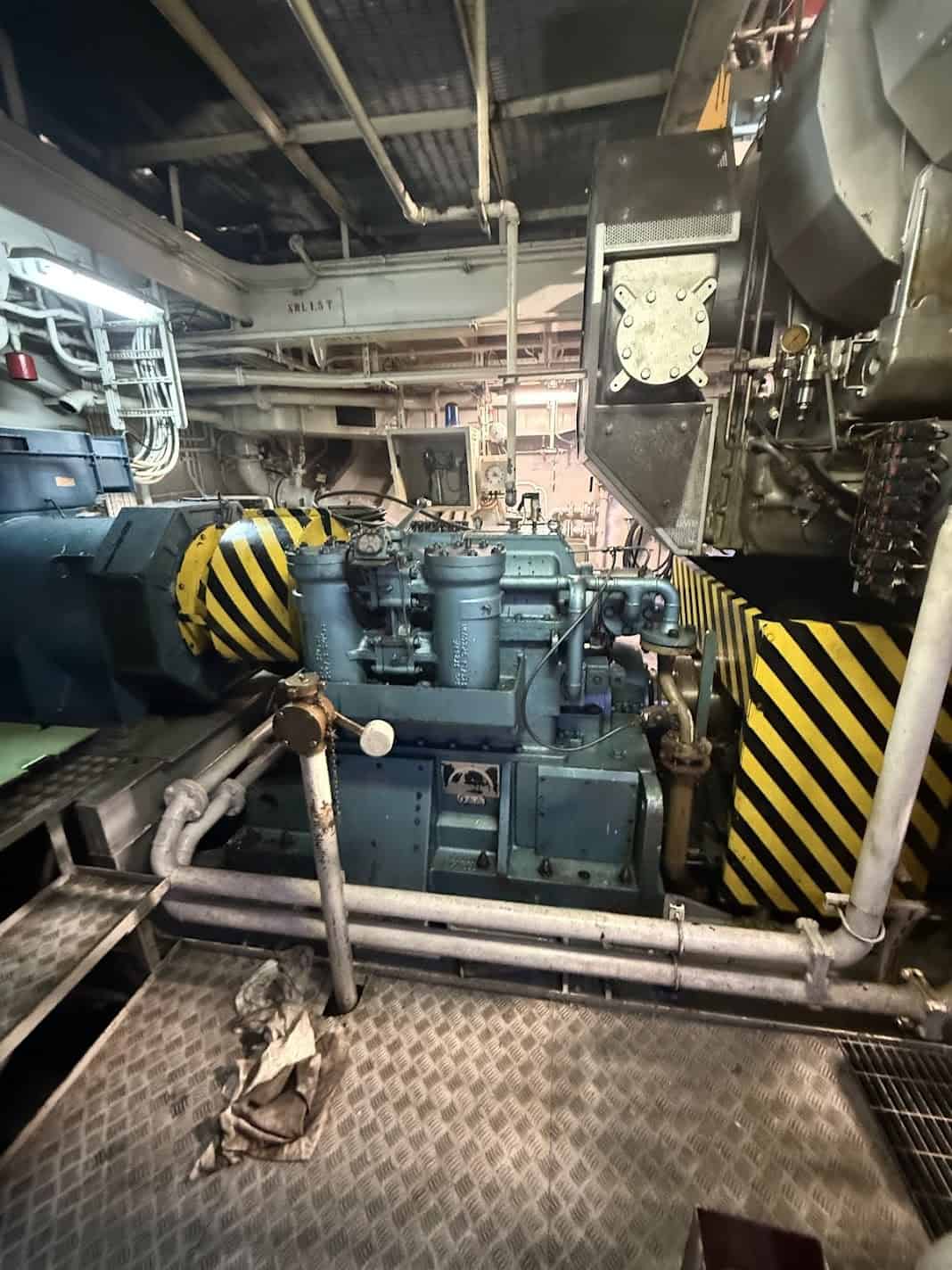 View of marine engine and machinery in ship's engine room.