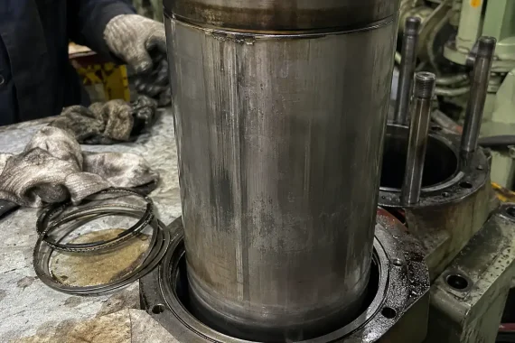 Close-up of a marine cylinder liner showing signs of scuffing and wear.